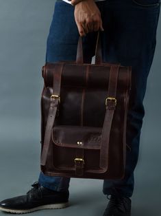 Trustpilot Hawk Roll-Top Backpack is handcrafted from genuine leather by highly skilled artisans from Jodhpur. Carry it anywhere without even thinking of any damage to the bag because it is created with the extra thick leather to survive in extreme conditions as it is primarily made for hiking. And also our creative craftsmanship with minute detailing is sure to steal your heart. It can easily fit your clothes, shoes, lunch, headphones, tablet, books, and files altogether in the main compartment Brown Leather Duffle Bag For Outdoor Activities, Leather Backpack For Hiking With Waxed Finish, Waxed Finish Leather Backpack For Hiking, Waxed Leather Backpack For Hiking, Leather Satchel Backpack For Outdoor Activities, Rugged Leather Hiking Backpack, Leather Backpack With Adjustable Strap For Outdoor Activities, Leather Backpack For Outdoor Activities, Outdoor Leather Backpack With Leather Lining