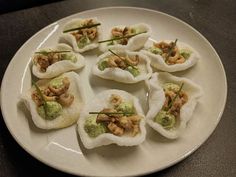 small appetizers are arranged on a white plate