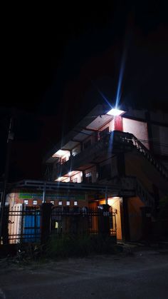 an apartment building lit up at night with bright lights