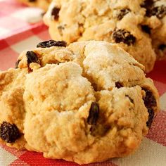 three cookies sitting on top of a red and white checkered table cloth