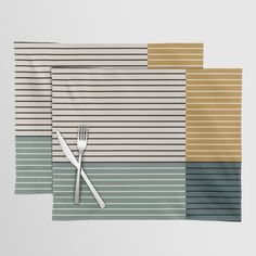 three placemats with forks and knives on top of each one in different colors