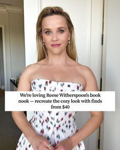 a woman in a white dress holding her hands on her hips with the caption, we're loving reese wherspoos book nook receive the cozy look with finds from $ 50