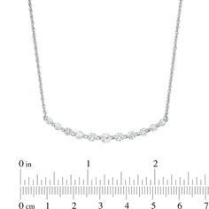 Understated yet elegant, this shimmering fashion necklace easily updates your look. Crafted in cool 10K white gold, this rope chain style is adorned with a row graduating lab-created bright white sapphires - the largest a 4.0mm center stone. Buffed to a brilliant luster, this glittering 18.0-inch necklace secures with a spring-ring clasp. 14k White Gold Brilliant Cut White Necklace, Refined White Gold Necklace With Brilliant Cut, Anniversary White Gold Necklace With Lab-created Sapphire, White Sapphire Graduated Necklace, White Gold Necklace With Diamond Cut Lab-created Sapphire, White Sapphire Necklace, Peoples Jewellers, Sapphire Necklace, Rope Chain