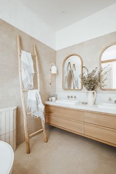 a bathroom with two sinks and a ladder in it