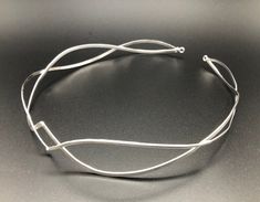 I have fabricated a sterling silver headpiece which is designed to be worn by either gender, either for a wedding, a Renaissance event, or hand-fasting ceremony. A unisex circlet with a Middle Earth feel! This is fabricated from 12 gauge wire. It's sturdy, strong and will last a lifetime of enjoyment. This piece will fit 3/4's around the head and is tied off, in the back, by an elastic jewelers cord so that it will remain snug and in place while in motion. This works better than using a chain li Silver Adjustable Choker For Weddings, Silver Minimalist Choker For Wedding, Minimalist Silver Choker For Wedding, Unique Silver Choker For Wedding, Modern Handmade Wedding Jewelry, Adjustable Crown Jewelry For Formal Occasions, Handmade Silver Headband Jewelry, Handmade Silver Jewelry Headband, Male Circlet