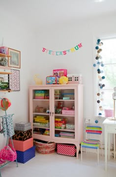 a room filled with lots of colorful items and decor on the walls, including bookshelves