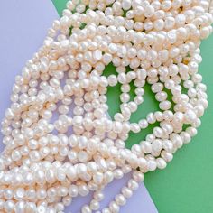 Creamy white "potato" pearls. Naturally unique in shape and texture. Measurements: Each pearl is approximately 8-9x6-7mm. Each strand approximately 16" with approximately 55 beads. Pearl White Oval Beads Pearl Necklace, White Oval Pearl Necklace, White Pearl Necklace With Round Beads And Pearl Charm, White Oval Beads Single Strand Pearl Necklace, White Single Strand Pearl Necklace With Oval Beads, White Pear-shaped Pearl Necklace With Charm, White Pearl Necklace With Pear-shaped Charm, White Pearl Charm Necklace In Pear Shape, White Potatoes