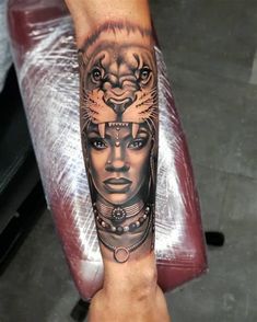 a woman's arm with a tattoo on it and a lion head in the middle