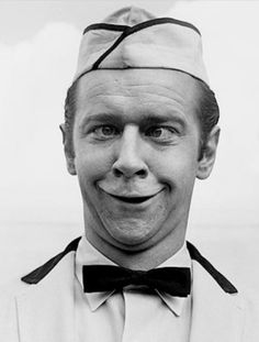 a man wearing a hat and bow tie