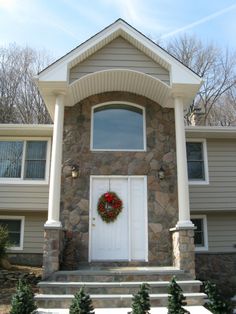 a house with a wreath on the front door