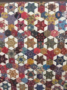 an old quilt with many different colors and patterns