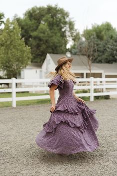 Effortless elegance comes to mind when thinking about our dreamy Solana Dress. Now available in a stunning purple lace. The adjustable corset tie on the bodice provides a personalized fit, while the short flutter sleeves add a touch of femininity. Featuring a square neckline, dazzling purple lace burnout fabric, hidden back zipper and maxi-length ruffle tiered skirt. fall aesthetic, pinterset outfit, fall outfit, family photos, country aesthetic, equestrian, lace dress, mommy & me Fitted Purple Dress With Ruffle Hem, Fitted Lavender Dress With Ruffle Hem, Purple Fitted Tiered Dress, Purple Lace Dress With Ruffles, Purple Lace Dresses With Ruffles, Feminine Purple Dress With Fitted Bodice, Purple Fitted Dress With Flutter Sleeves, Fitted Purple Dress With Flutter Sleeves, Fitted Purple Dresses With Flutter Sleeves