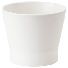 a white cup sitting on top of a table