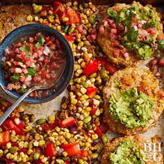 an overhead view of food on a baking sheet with a spoon in it and corn