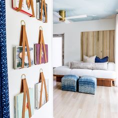 a living room filled with furniture and pictures on the wall next to a white couch