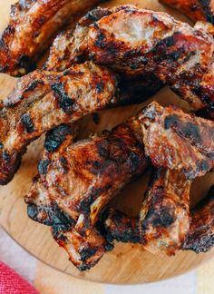 some chicken wings are in a basket on the table and ready to be eaten with sauce