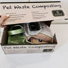 the pet waste composting box is open to reveal its contents