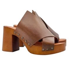 "In a woman's wardrobe, heeled sandals cannot be missing, which give that touch of style that a woman needs. The wide heel and the plateau of our clogs offer incredible comfort, slender your figure, with minimal effort. Women's clogs with brown wood effect base Upper in brown leather, with wide crossed band Soft padded insole Open toe 8.5 cm wide heel and 3 cm plateau Entirely made by specialized Italian personnel Handcrafted using the best materials. Designed & Produced By \"MY Clogs\" BEFORE P Medium Width Open Heel Mules With Heel Loop, Mules With Heel Loop And Medium Width, Wrapped Heel Medium Width Closed Toe Mules, Brown Sandals With Reinforced Heel And Medium Width, Summer Clogs With Deep Heel Cup And Open Heel, Summer Clogs With Deep Heel Cup And Round Toe, Leather Clogs With Wrapped Heel And Closed Toe, Brown Sandals With Block Heel And Deep Heel Cup, Brown Sandals With Reinforced Heel