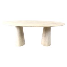 an oval table with two legs and a white marble top, against a white background