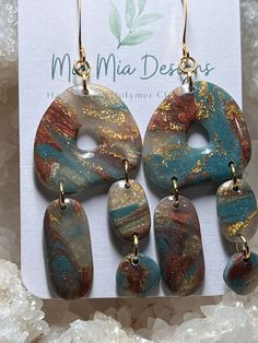 These adorable abstract earrings are handcrafted using translucent polymer colored with blue, rust with added gold leafing to create a one-of-a-kind pair of earrings.  Assembled using gold embellishments, these earrings are both lightweight and hypoallergenic. Bohemian Gold Resin Earrings, Handmade Turquoise Resin Earrings, Turquoise Resin Earrings For Gift, Artsy Blue Teardrop Earrings, Turquoise Dangle Earrings In Resin, Artsy Resin Dangle Earrings, Artsy Blue Polymer Clay Earrings, Artsy Blue Dangle Earrings, Artsy Resin Earrings With Ear Wire