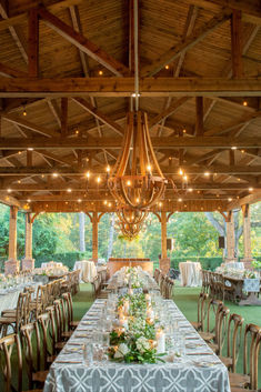 an outdoor venue with tables and chairs set up for a formal function in the evening