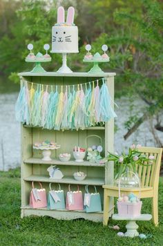 an old book shelf with some decorations on it and a bunny cake in the background