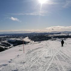 a person standing on top of a snow covered slope