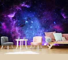 a living room filled with furniture next to a wall covered in purple and blue stars