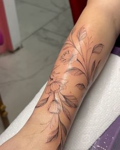 a woman's arm with flowers on it