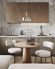 a kitchen with marble counter tops and white chairs around a round wooden table in the center