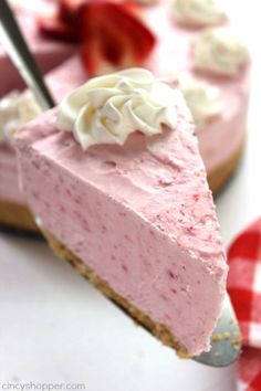 a slice of strawberry cheesecake with whipped cream on top