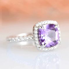 Elegant Wedding Amethyst Gemstone Ring, Sterling Silver Gemstone Halo Ring For Wedding, Elegant Amethyst Rings For Wedding, Elegant Purple Wedding Ring, Formal Purple Halo Birthstone Ring, Elegant Amethyst Wedding Ring With Center Stone, Amethyst Cubic Zirconia Ring With Halo Setting For Anniversary, Formal Purple Birthstone Ring With Halo Setting, Purple Cushion Cut Jewelry For Wedding