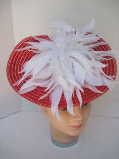 "* Red and White always looks so fresh and clean and this one is designed with lots of white spiky feathers that catch the breeze giving a feminine flair to the fascinator. * The hat form is about 12\" folded in back and tilted in a sophisticated design. * It is light weight, balanced and comfortable to wear year round. * Designed on a metal headband, it fits just about any head size and when viewed from any direction it looks complete, striking and eye catching. * Wear it throughout the year fo White Ostrich Feather Hat For Kentucky Derby, Summer Hat With Ostrich Feather Trim, White Mini Hat With Feather Trim For Summer, White Mini Hats With Feather Trim For Summer, White Hats With Feather Trim For Races, White Mini Hats With Feathers For Royal Ascot, White Feather Trim Mini Hat For Summer, White Feathered Costume Hats For Summer, Summer Ostrich Feather Hat With Feathers