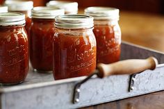 several jars of tomato sauce sit on a tray