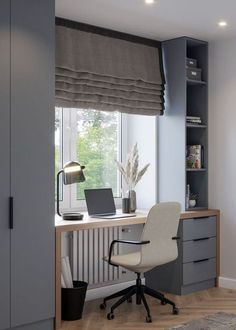 a desk with a laptop computer on top of it next to a book shelf and window