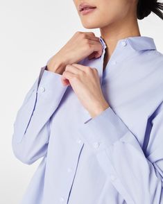 The classic button-down just got a whole lot more luxurious. Crafted from premium cotton with a super-fine yarn count, this lightweight yet durable fabric is perfect for year-round wear. Plus, it’s machine washable for easy maintenance. Designed with an oversized fit and high-low shirttail hem for the perfect amount of coverage, it looks great whether tucked or untucked. Pair it with any of our pants to instantly elevate your look. | Spanx Women's Poplin Oversized Button-Down Top Poplin Shirt With Button Closure For Daywear, Poplin Button-up Shirt With Buttons, Spring Button-up Dress Shirt With Button Cuffs, Button-up Dress Shirt With Button Cuffs For Daywear, Dress Shirt With Button Cuffs For Daywear, Spring Workwear Dress Shirt With Button Closure, Spring Poplin Shirt With Button Closure, Spring Dress Shirt With Button Cuffs, Spring Workwear Dress Shirt