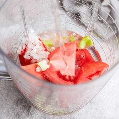 a blender filled with watermelon and other ingredients