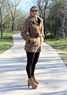 "Bohemian goddess vibes in this short coat / vegan jacket from London Leathers Lilli Ann.  Vintage 1960s.  Taupe faux fur and faux suede. Metal fur hooks in front. Matching faux suede belt that ties around the waist.  In-seam hip pockets. Lined.   CONDITION: very good vintage APPROXIMATE MEASUREMENTS: shoulder to hem: 33 1/4\" bust: 35\" waist: 30\"  hip: 39\" sleeve length: 23 1/2\"  Please visit our shop at: https://mezcalandleather.etsy.com At Mezcal + Leather, we spend many hours a week poring over racks and racks of less than stellar pieces looking for just the right items for you. We search the deepest, darkest crevices of vintage and consignment shops, thrift stores, estate sales and the closets of friends to find those things that take our breath away. We hope they take yours away Fitted Faux Fur Mink-colored Outerwear, Vintage Fur Coat With Faux Fur Lining For Spring, Fitted Brown Fur Coat For Spring, Brown Fur Coat With Faux Fur Lining For Spring, Brown Faux Fur Lined Coat For Spring, Spring Brown Fur Coat With Faux Fur Lining, Fitted Mink-colored Fur Coat For Spring, Lilli Ann Coat, 1960s London