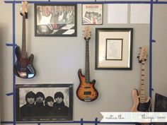 a wall with guitars and pictures on it