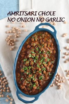 a blue casserole dish filled with beans and garnish