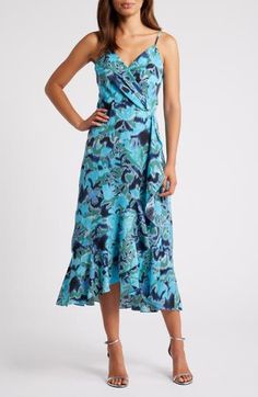 This sleeveless midi, fashioned with a wrapped bodice and a ruffled high/low skirt, is sure to be a warm-weather favorite. 33" to 41 1/2" center front length (size Medium) Hidden back-zip closure Surplice V-neck Adjustable straps Lined 99% polyester, 1% spandex Machine wash, line dry Imported Blue V-neck Wrap Dress With Ruffles, Sleeveless Floral Wrap Dress For Vacation, Blue High-low Hem Midi Dress For Spring, Blue Midi Dress With High-low Hem For Spring, Blue Wrap Dress With Surplice Neckline For Summer, Chic Blue Sleeveless Wrap Dress, Blue Wrap Dress With Surplice Neckline For Beach, Sleeveless Wrap Dress For Spring Vacation, Blue Surplice Neckline Wrap Dress For Beach