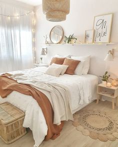 a bedroom with white walls and wooden flooring is decorated in neutral tones, such as beige