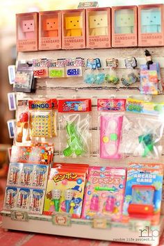 there is a toy store display with many items on the shelf and in plastic bags