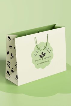 a white paper bag with the words lucuna on it sitting on a green surface