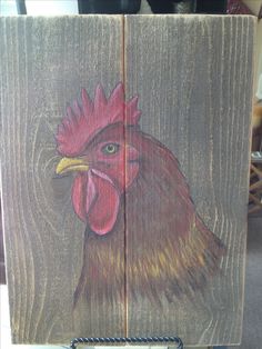 a drawing of a rooster on wood