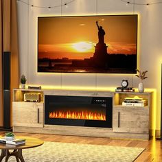 a living room with a large television mounted on the wall and a fire place in front of it