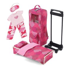 a pink suitcase with clothes and accessories in it, including a doll's outfit