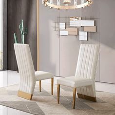 two white chairs sitting next to each other in front of a mirror on the wall