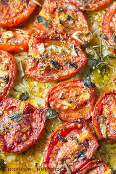 sliced tomatoes on a baking sheet ready to be cooked in the oven for roasting