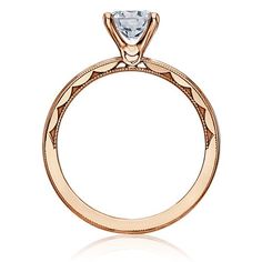 an 18k rose gold engagement ring with a diamond center